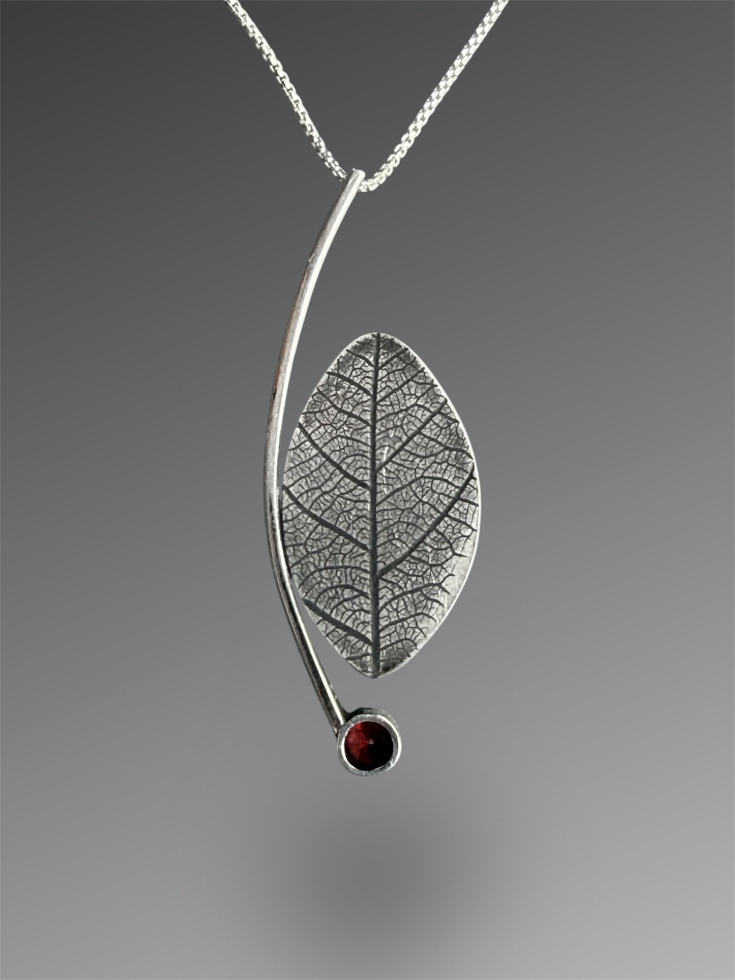 Crescent Curve Necklace with Fossilized Palm and Garnet