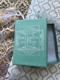 Photo of sage green gift box on wrapping paper